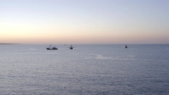 Fishing Trawlers at Sunrise Out at Sea