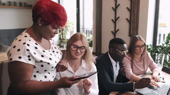 Busines Young People on a Meeting at a Cafe