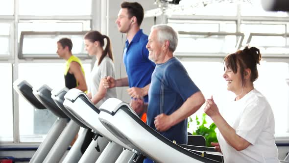 Energetic Senior Woman Exercising on Treadmill.