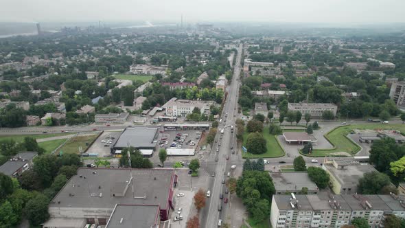 Aerial View of a Small Town Urban Landscape Flying By Houses Near Green Spaces