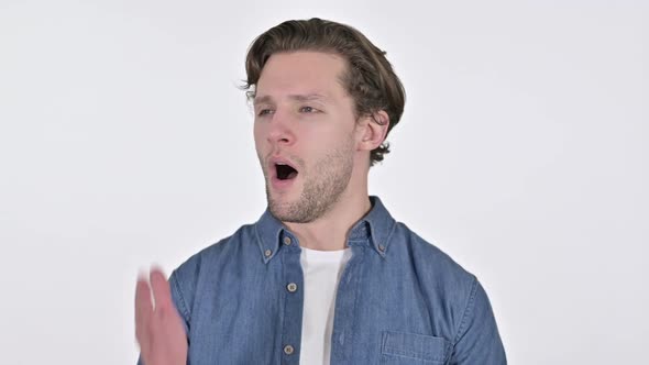 Portrait of Tired Young Man Yawning on White Background