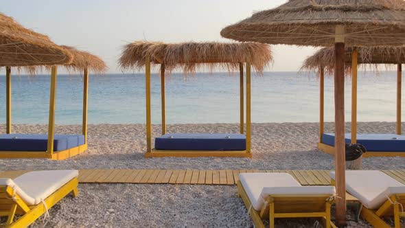 Canopy Beach Bed with White Curtains on an Empty Beach in Summer