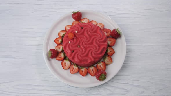 Pink Strawberry Cake Spins on a White Plate