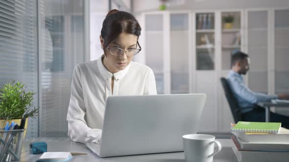 Cute 30s Sexy Female Working at Desk in Stylish Modern Business Office Using Computer for Email