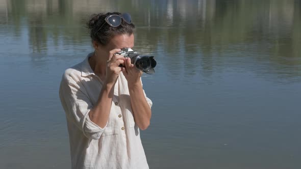 Female photographer focuses. 