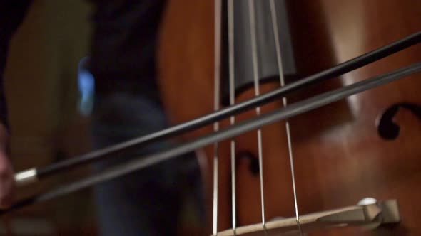 Footage Of A Musician Playing A Double Bass With A Bow