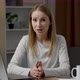 Smiling young caucasian woman telling something into webcam. Female has video call - VideoHive Item for Sale