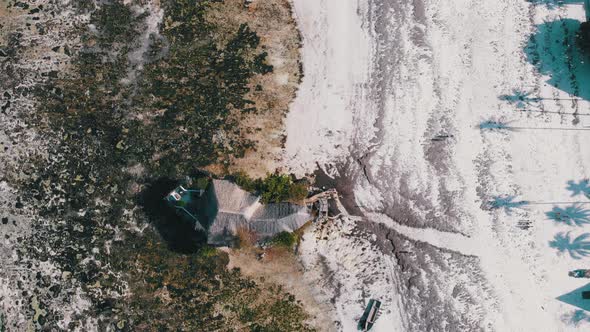 The Rock Restaurant in Ocean Built on Cliff at Low Tide on Zanzibar Aerial Top