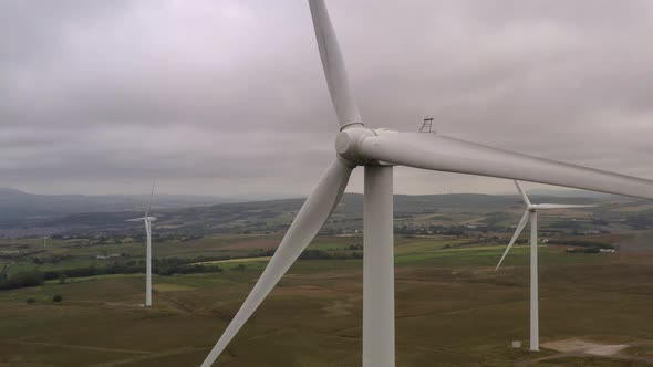 A close up of a wind turbine in a field