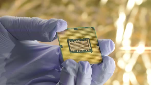 Processor for Neural Engine in Gloved Hand of Scientist in Research Laboratory