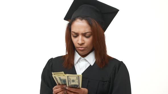 Dissapointed African American Female Graduate Counting Dollars and Doesn't Understand What's Going