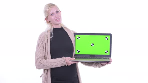 Happy Young Blonde Pregnant Woman Talking While Showing Laptop
