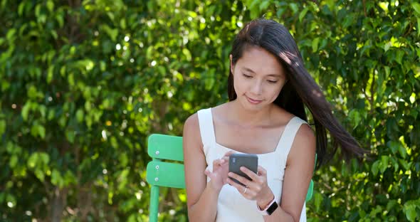 Woman Use of Mobile Phone in The City Park