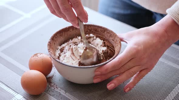 Dough Preparation  Woman Mixing Cocoa Powder and Flour in Ceramic Bowl