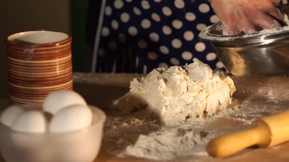 Close Up Shot of Woman's Hands Who Spreads From Bowl Resulting Dough on Table