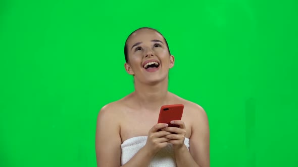 Spa Woman Sends Message on Mobile with Happy Smile. Green Screen. Slow Motion