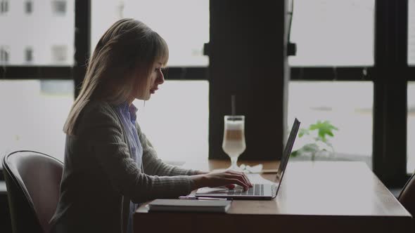 Mixed Race Woman Working From Home on Laptop Computer