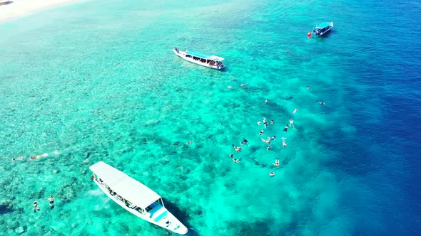 Aerial drone shot landscape of marine coast beach lifestyle by blue sea with white sand background o