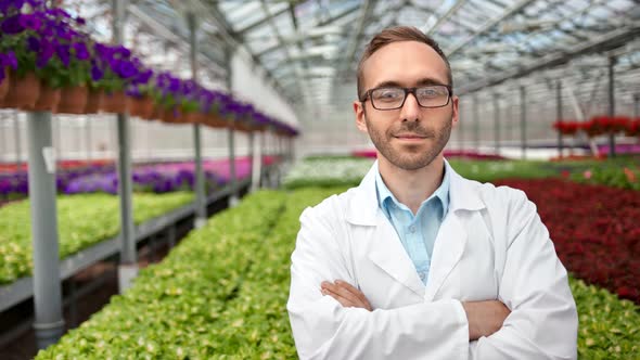 Medium Shot Portrait of Smiling Confident Male Science Farmer Posing in Greenhouse Looking at Camera