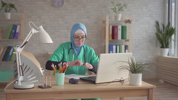 Portrait Muslim Woman in Hijab Doctor at Workplace in Modern Clinic