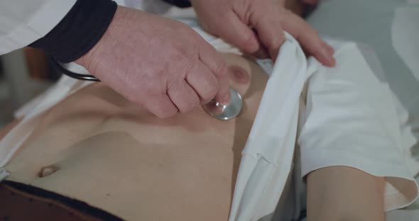 Close View of Doctor Listens to Sick Boy's Breath with Phonendoscope in Hospital