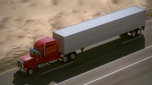 Huge semi-trailer cargo truck riding on the highway. Aerial view. Loopable. HD