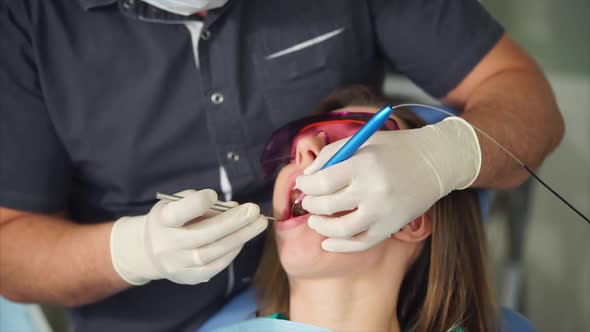 Dentist Using Laser to Provide Teeth Treatment