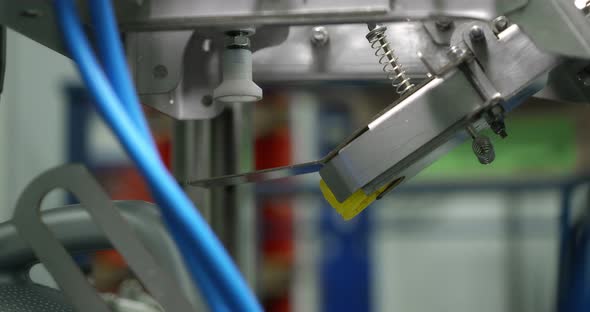 Gray Plastic Bottles Move Along a Conveyor Line to Fill and Pack Motor Oil