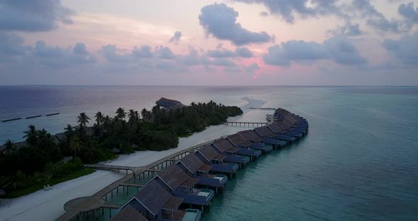 Tropical birds eye copy space shot of a white sandy paradise beach and aqua blue water background