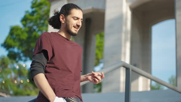 Closeup Portrait of Handsome Arab Man Sitting in the Park