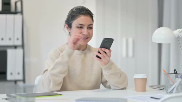 Indian Woman with Smartphone Celebrating Success