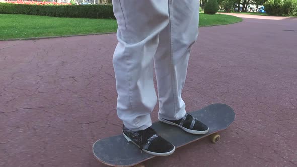 Close up of legs on skateboard
