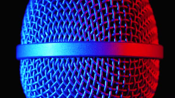 Microphone Rotates with Blue and Red Backlight. Dynamic Microphone Grid Spins Close-up