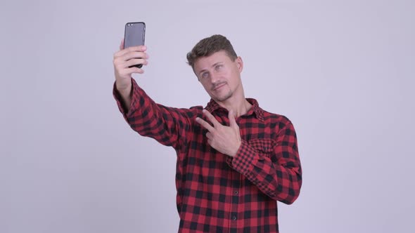 Happy Bearded Hipster Man Taking Selfie with Phone