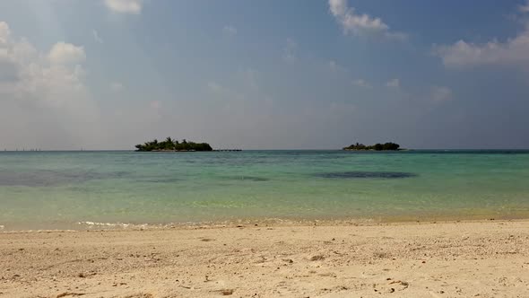 Low angleing toward seashore from sandy beach in Maldives