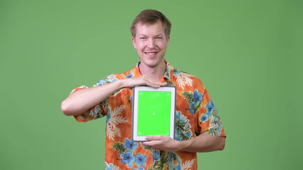 Young Happy Handsome Tourist Man Showing Digital Tablet