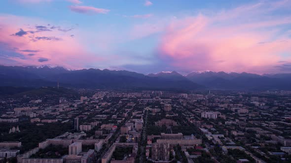 Pinkblue Large Clouds Over the City and Mountains