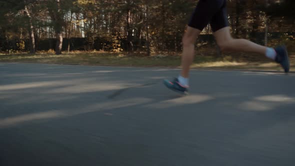 Triathlete Running,Sprinting And Endurance Marathon Workout.Runner Man Fit Athlete Legs Jogging Run.