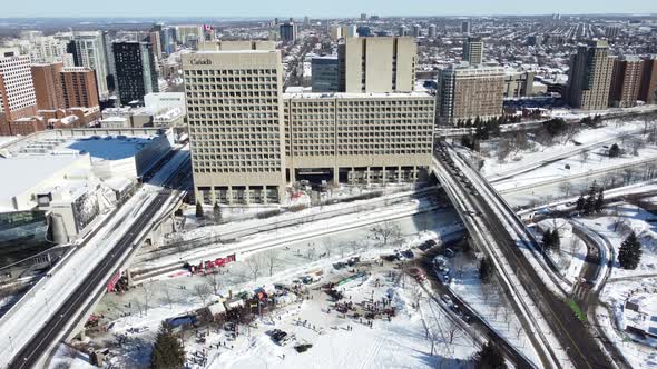 Aerial view of the frozen Rideau Canal with trucks and people joining the peaceful protest of the fr