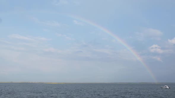 Rainbow Over the River and Sailing Boat