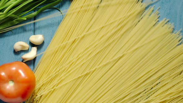 Spaghetti Falling Down On The Blue Wooden Table