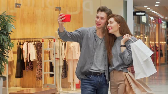 Young Couple Taking Selfies While Shopping at the Mall Together