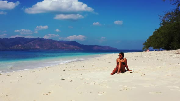 Beautiful ladies tanning on luxury island beach holiday by blue sea with bright sand background of G