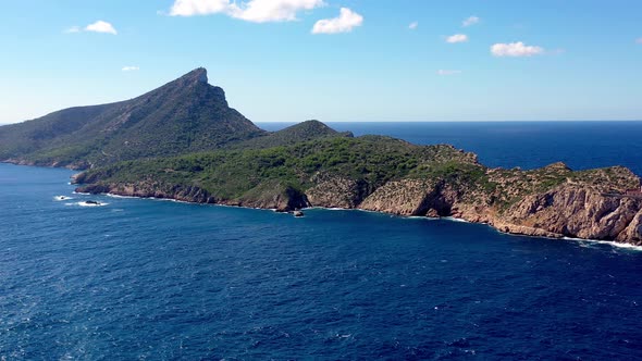 Sa Dragonera island on Mallorca Spain with Tramuntana lighthouse and Pico Popi peak behind, Aerial r