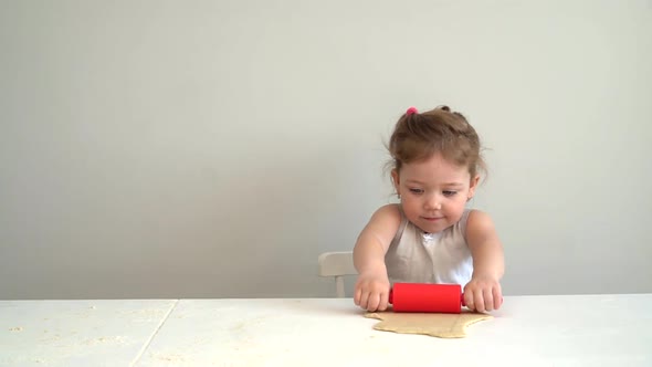 Little Girl Rolling-pin Dough on the Kitchen for Pie