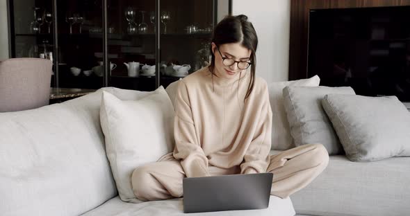 Woman Using Laptop at Home