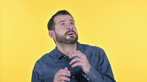 Ambitious Beard Young Man Looking Side Ways, Yellow Background