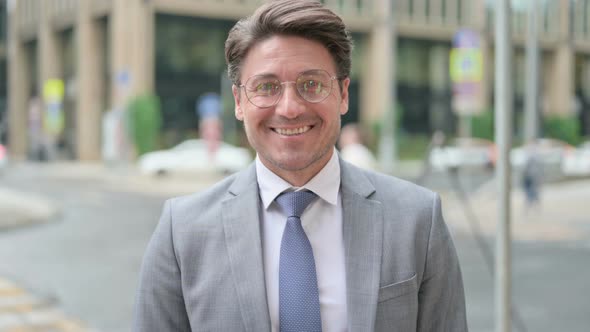 Smiling Businessman Standing in Street