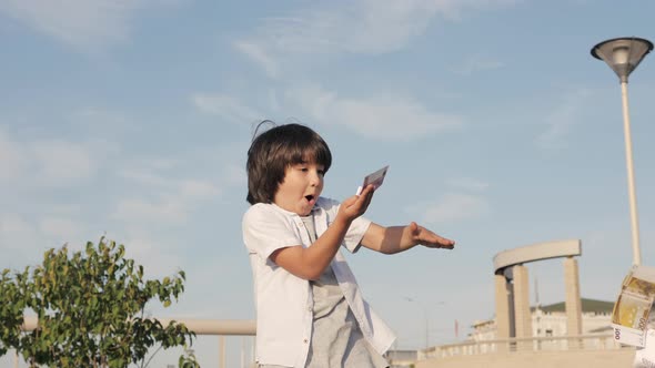 Happy Boy Throws Money in the Air