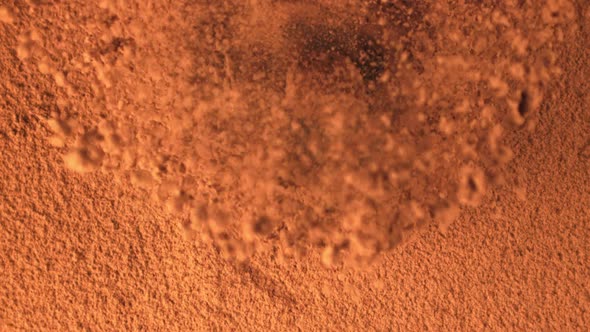 Super Slow Motion Truffle Falls Into Cocoa Powder